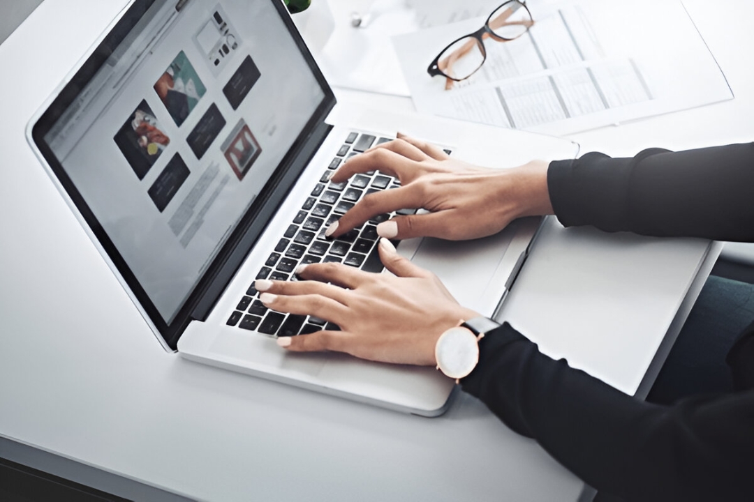 A person works on a laptop with three checked real estate screens, showing optimizing REI website landing pages from AMPLIFIREI. A person works on a laptop with three checked real estate screens, showing optimizing REI website landing pages from AMPLIFIREI.