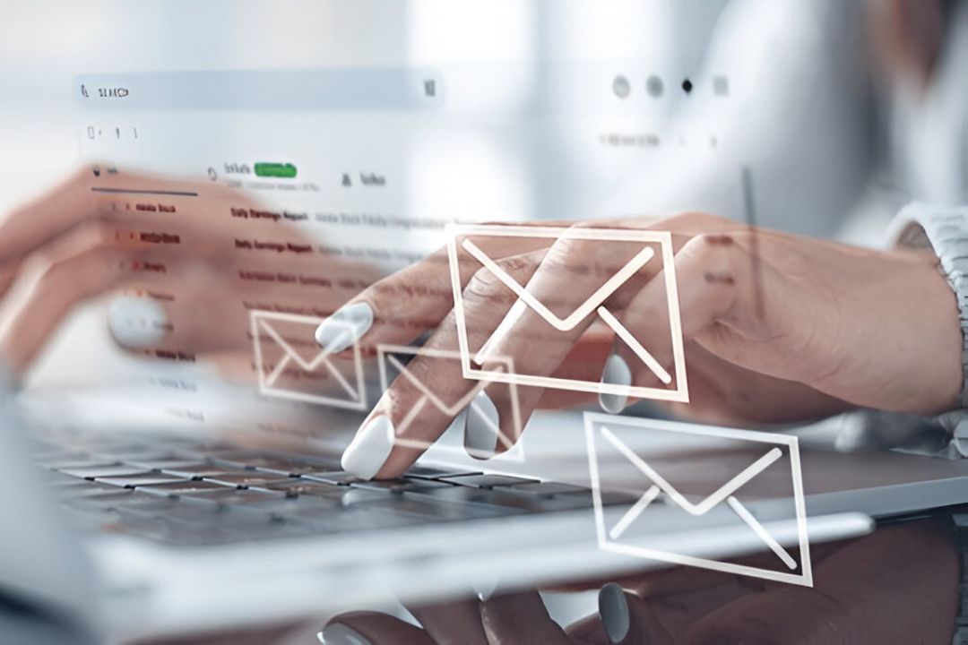 A person's hands type on a laptop with floating email icons, showing marketing automation best practices from AMPLIFIREI. A person's hands type on a laptop with floating email icons, showing marketing automation best practices from AMPLIFIREI.
