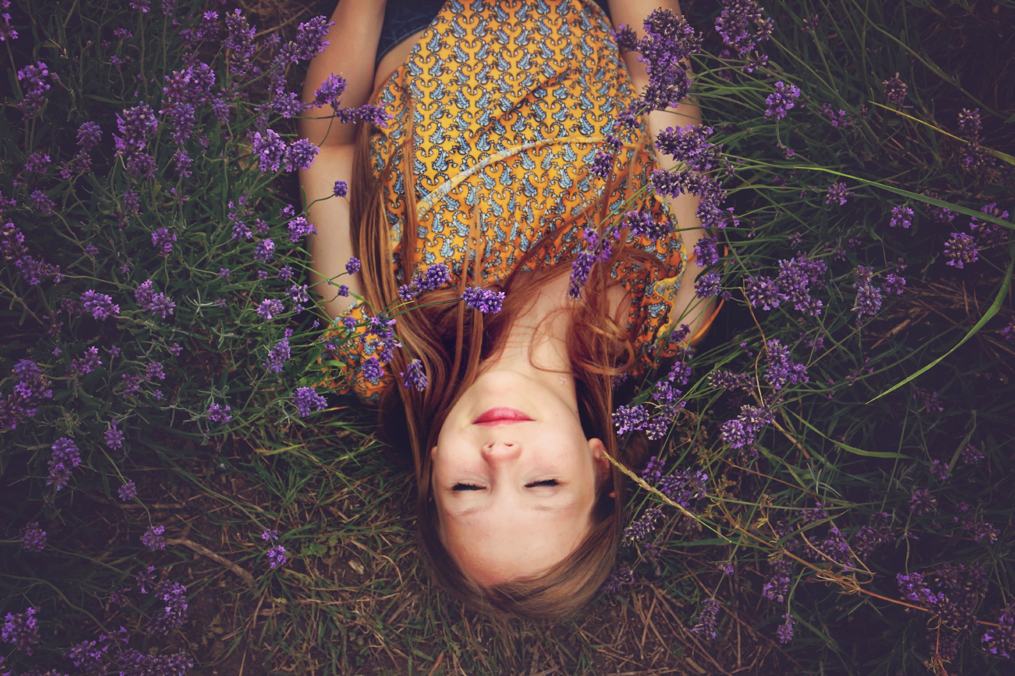 woman relaxing amongst purple flowers