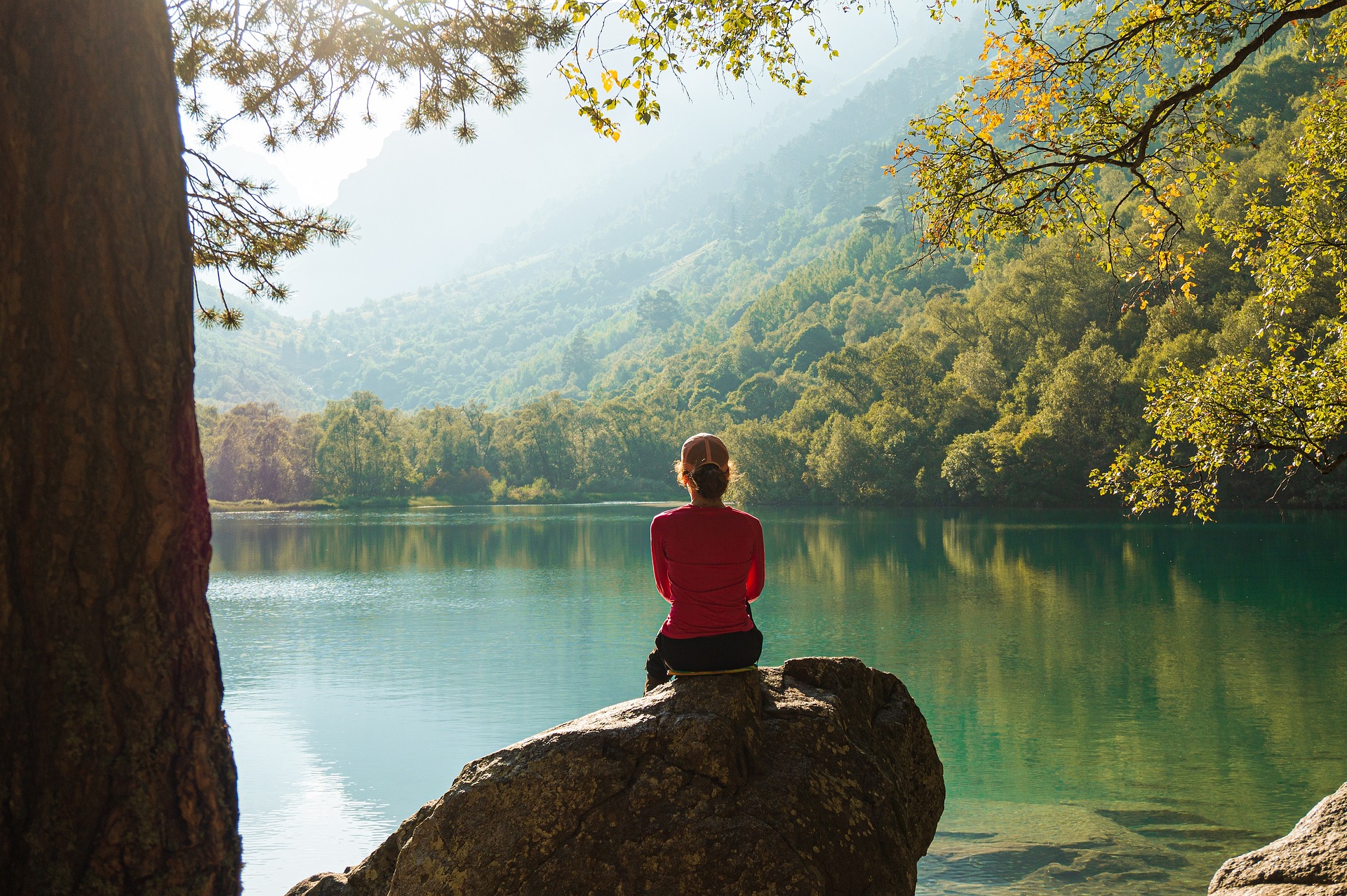 Woman sits in meditation in nature