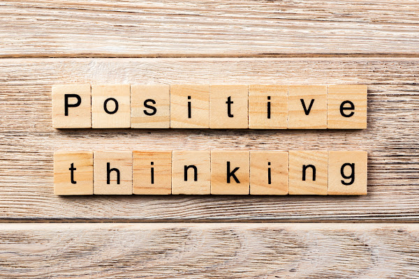 wooden Scrabble tiles spelling Positive Thinking