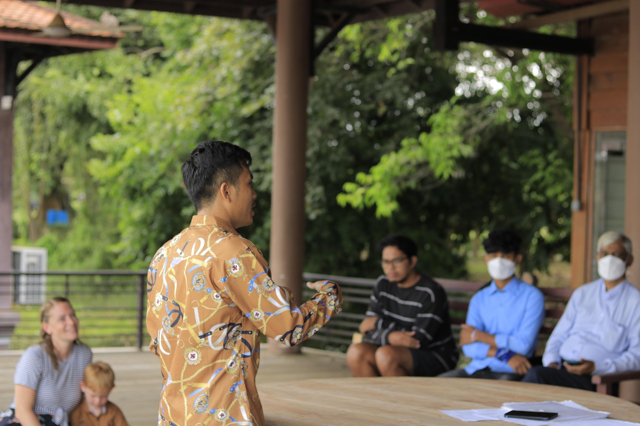 Man speaking to a small group of people during an outdoor meeting, symbolizing leadership, discipleship, and Christian service in a community setting. Man speaking to a small group of people during an outdoor meeting, symbolizing leadership, discipleship, and Christian service in a community setting.