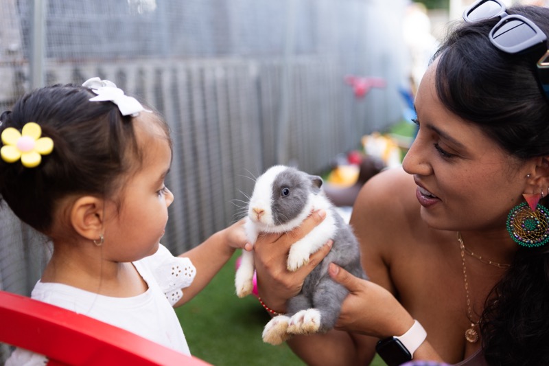 girl and mom holding bunny at Easter girl and mom holding bunny at Easter