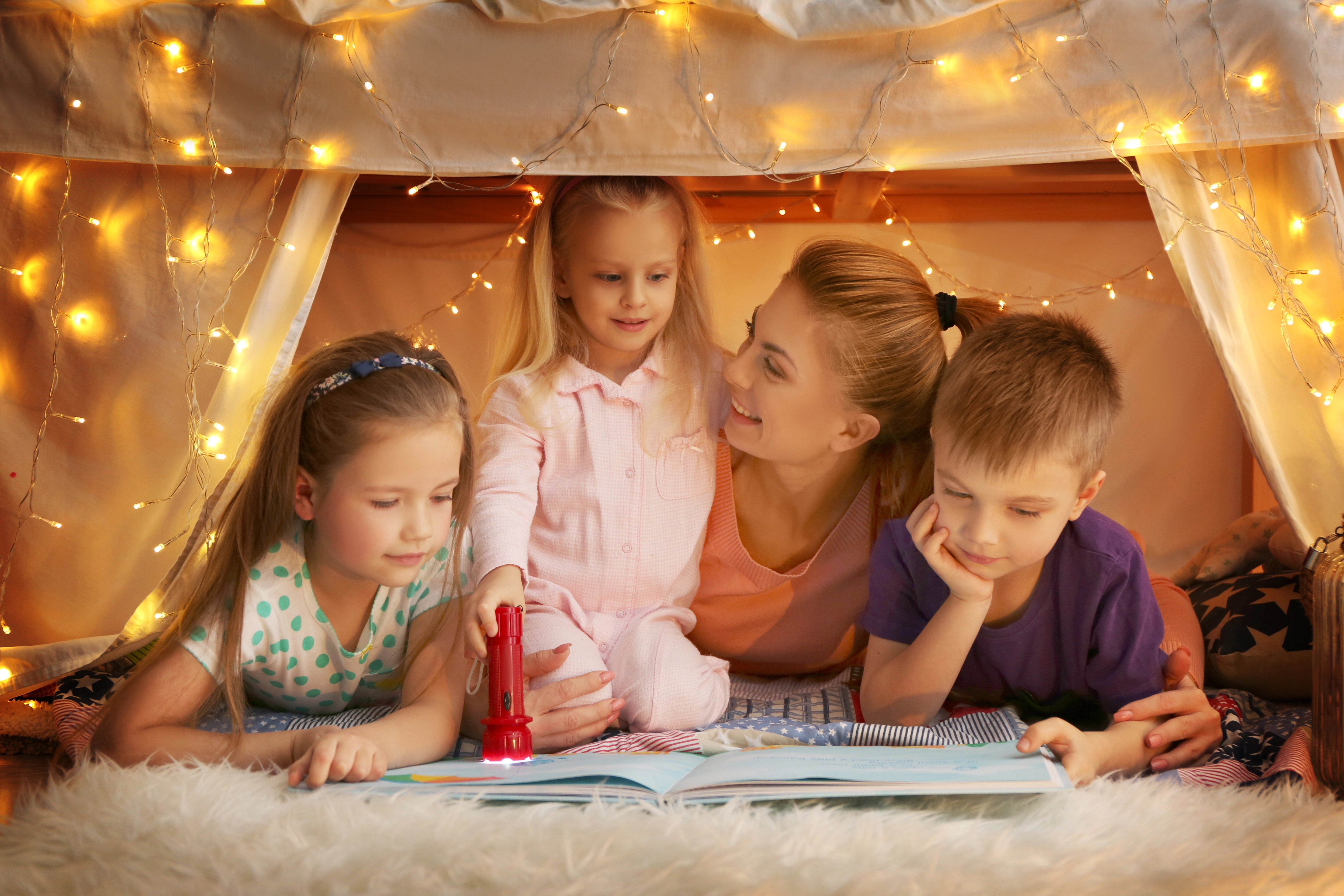 A homeschool mom reading to her cute children during morning time A homeschool mom reading to her cute children during morning time