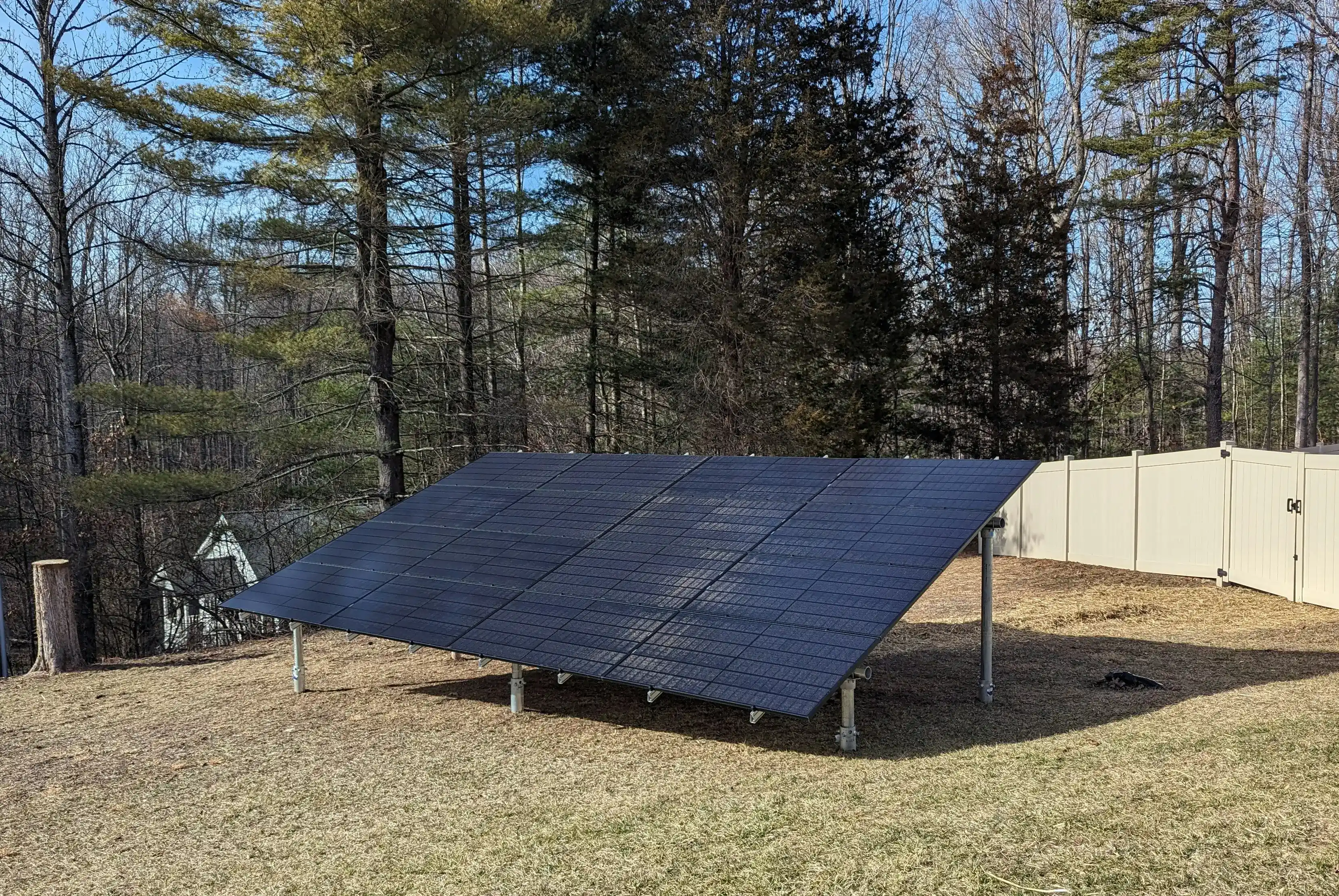 Ground-mounted solar panels installed in a residential garden.