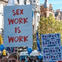 hand-painted sign that says sex work is work
