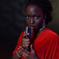 woman in red holding an old-fashioned microphone