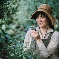 gardener holding a white flower