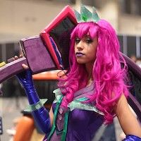 woman in cosplay with pink wig and giant foam hammer