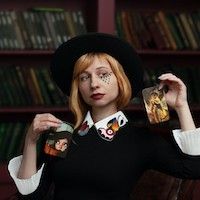 person holding colorful tarot and playing cards