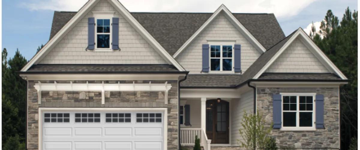Modern home featuring a white garage door with decorative windows