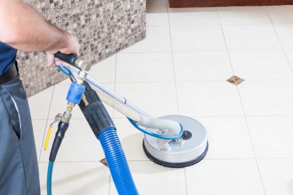 Tile and grout cleaning with a professional high-pressure machine.