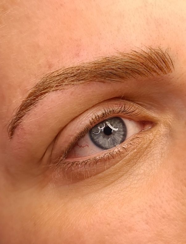 Close-up image of a stunning Combo Brow treatment at Feather Touch Aesthetics in Hobart. This perfectly tailored eyebrow enhancement combines microblading and shading techniques for a natural yet defined look. Showcasing the precision and artistry of our skilled brow artists, the result is beautifully full and balanced brows that enhance the client's natural features