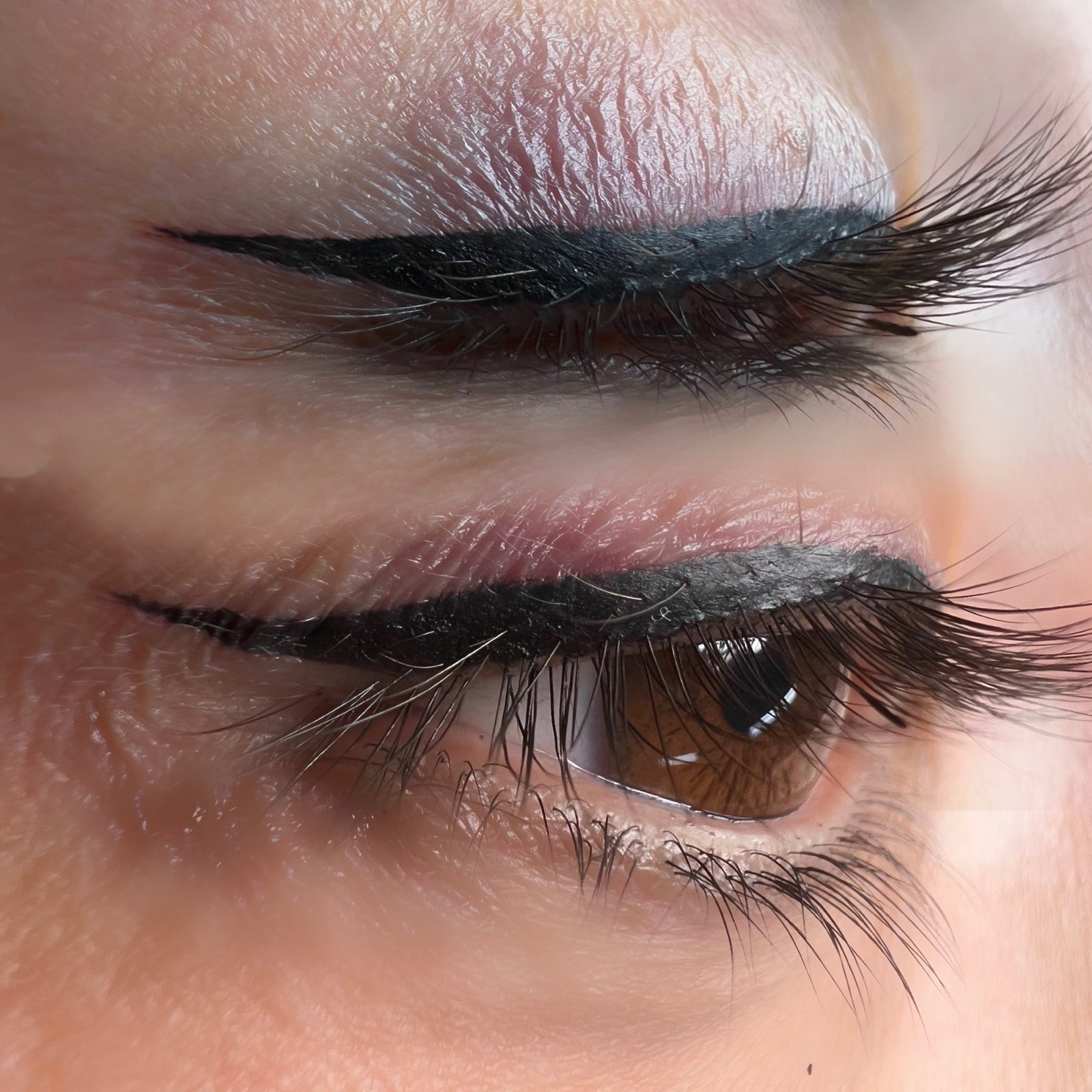 Winged eyeliner, cosmetic tattoo. Top only eyeliner