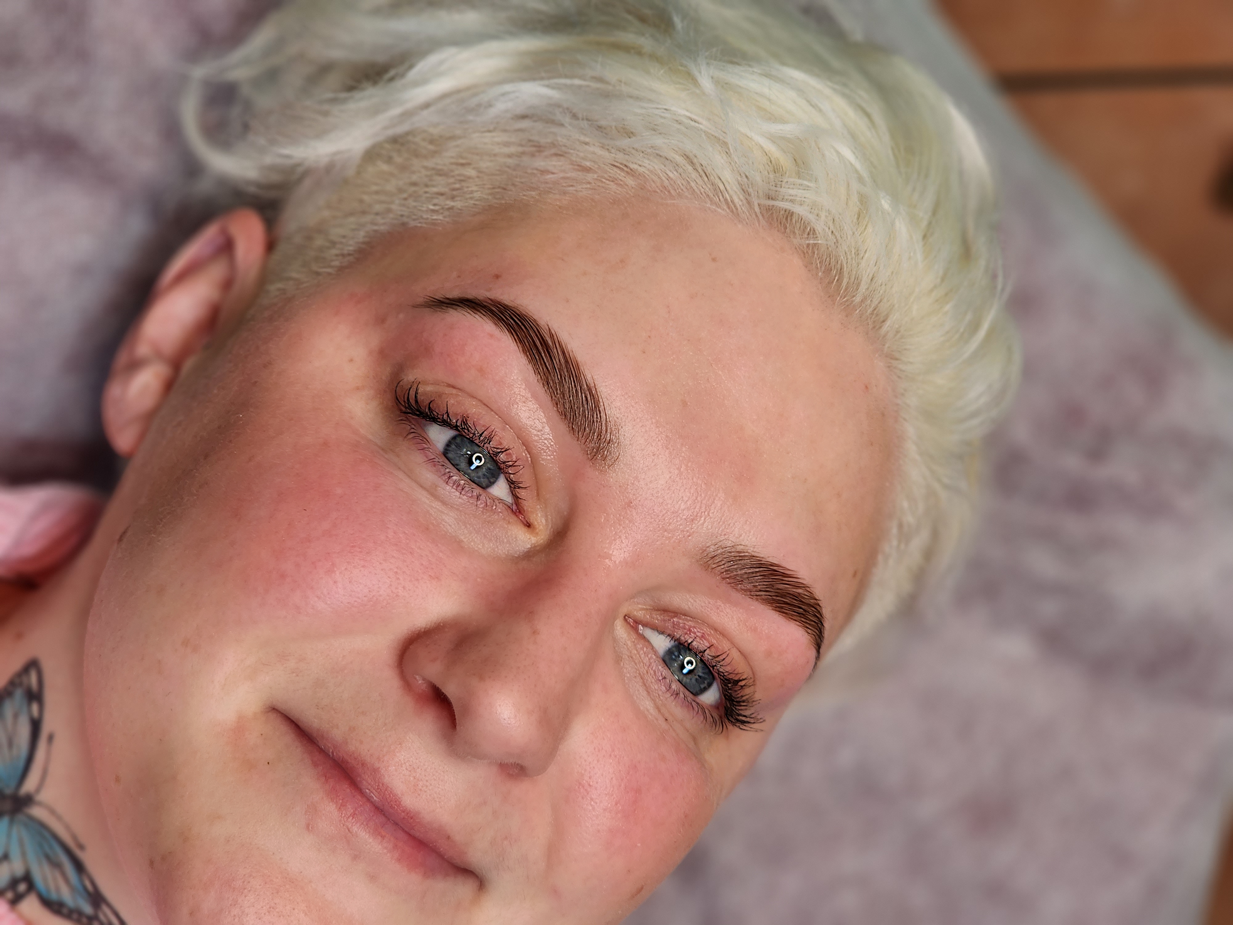 Beautifully laminated brows on a smiling client at our Hobart clinic, highlighting the stunning, natural-looking results achieved through brow lamination