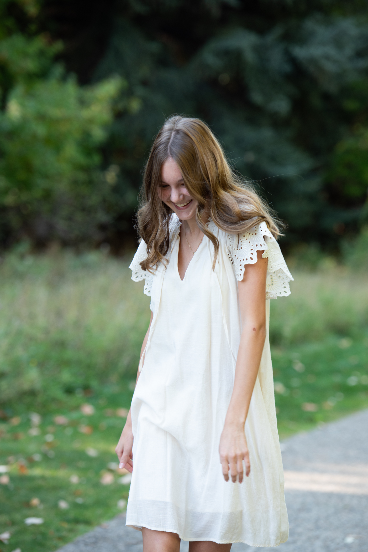 girl walking with smile in white dress