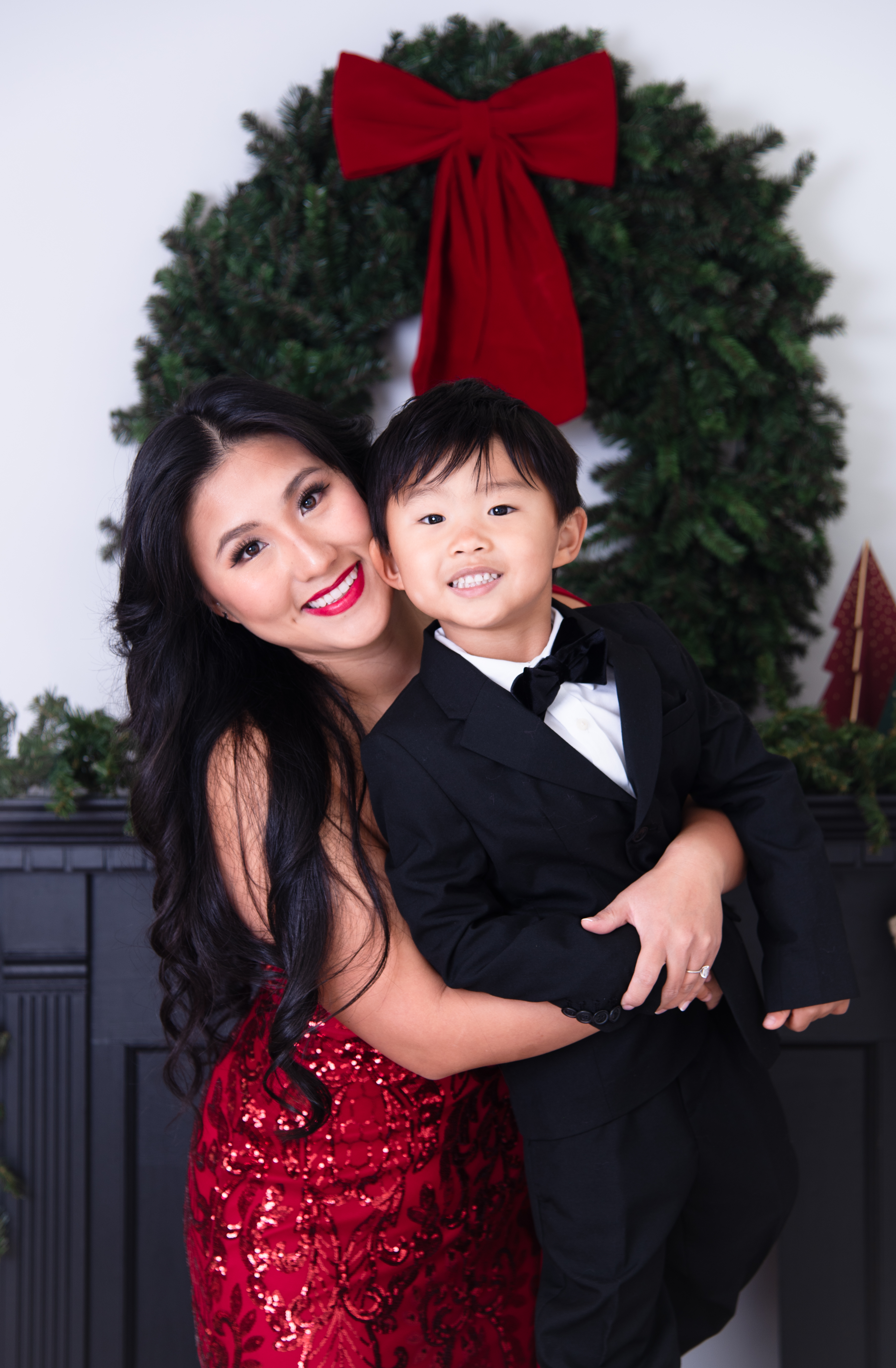 boy and his mother Miss Idaho 2025 smiling in their holiday dress up at Flaming and Palm Studio