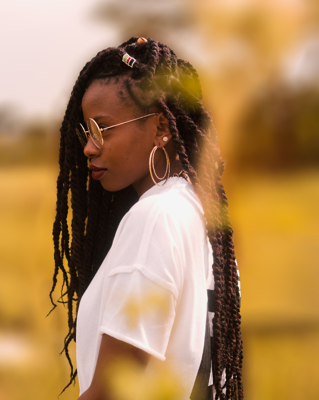 black woman in field in contemplation