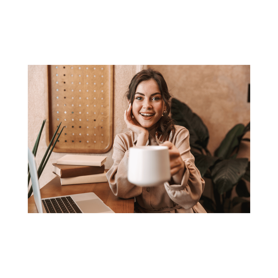 A Laptop Momma smiling and holding a coffee cup, working on her online digital marketing business at a cozy home desk with a laptop and books, representing the blend of faith and entrepreneurship. A Laptop Momma smiling and holding a coffee cup, working on her online digital marketing business at a cozy home desk with a laptop and books, representing the blend of faith and entrepreneurship.