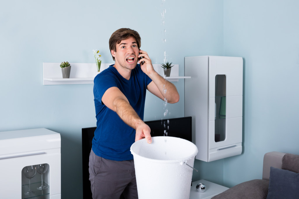 Calling a plumber to fix burst pipe