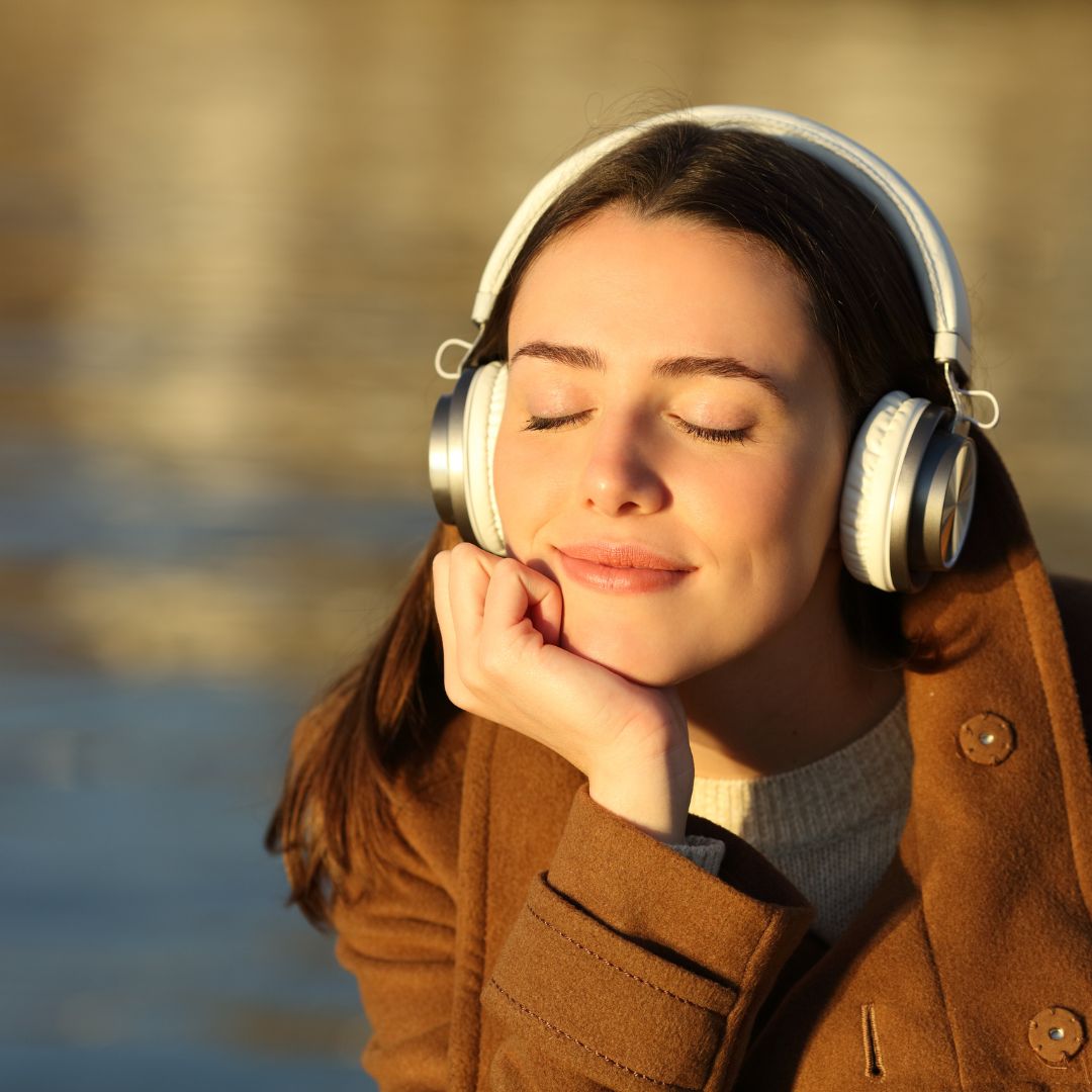 A family member listening to a ReLiveable hospice voice memorial, finding solace in their loved one’s voice.