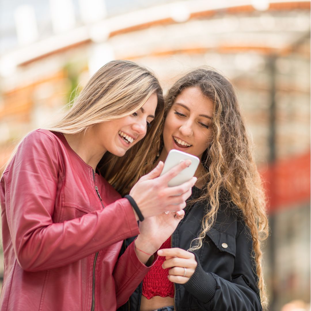 A woman listens to an Interactive Voice Memorial in her native language from ReLiveable’s AI Memorial Services, preserving cultural heritage.