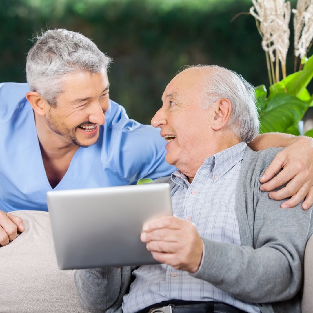 A hospice caregiver plays an Interactive Voice Memorial from ReLiveable’s AI memorials for hospice care for a family