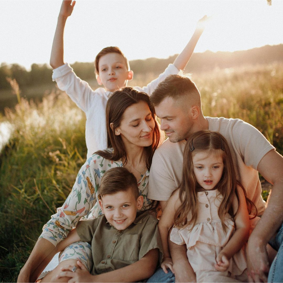 A family visits a gravesite, contrasted with a phone displaying ReLiveable’s AI Memorial Services Interactive Voice Memorials.