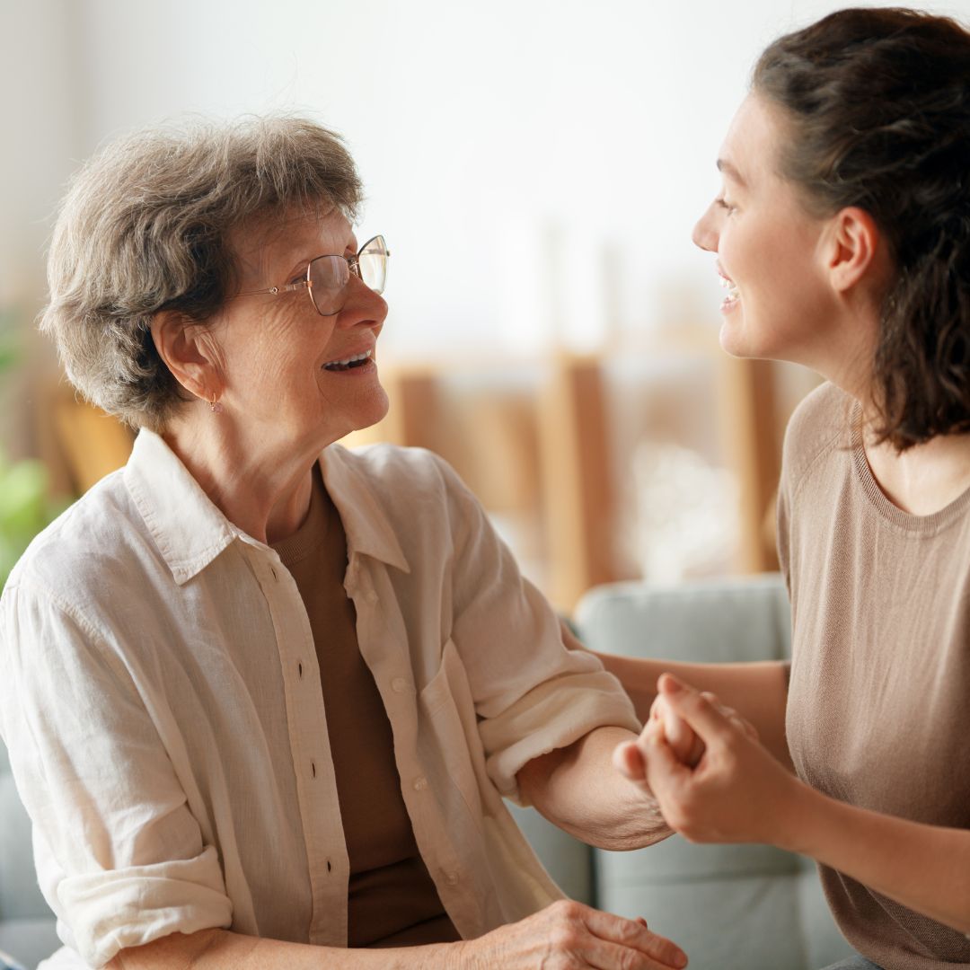 A hospice caregiver demonstrates ReLiveable’s cost-effective AI memorials for hospice care to a family.