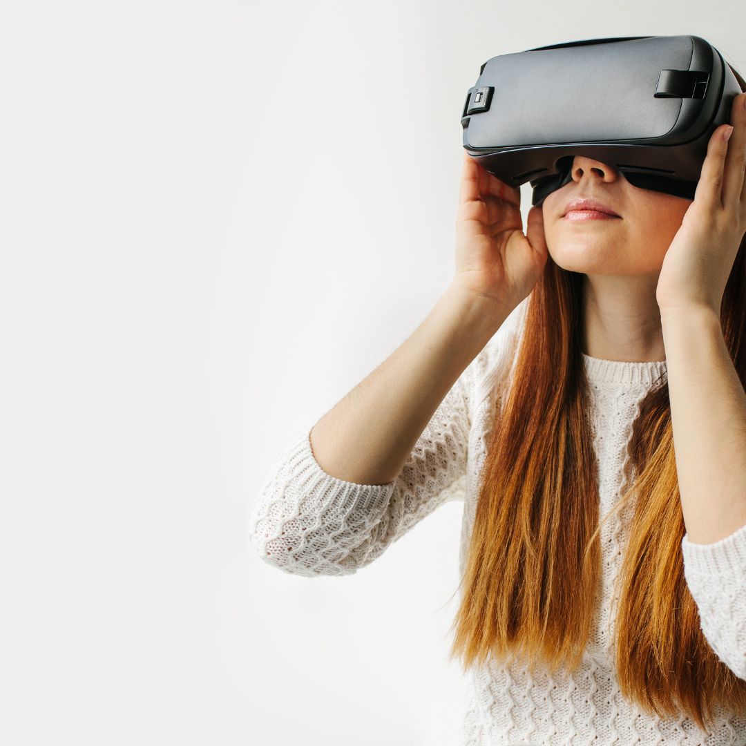  A woman in a VR headset interacts with a virtual memorial space from ReLiveable’s AI Memorial Services.