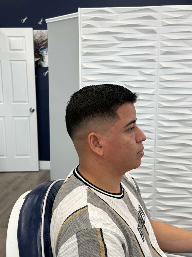 Customer finishing touch (hair product) being applied by barber, hands in motion and product droplet detail, cinematic micro-action.