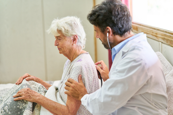 Doctor Listening to a Senior with a Stethoscope Doctor Listening to a Senior with a Stethoscope