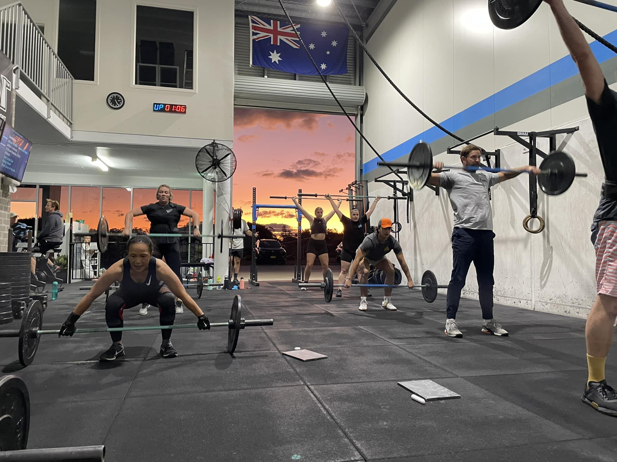 Members squatting at Clarence Valley CrossFit at sunset