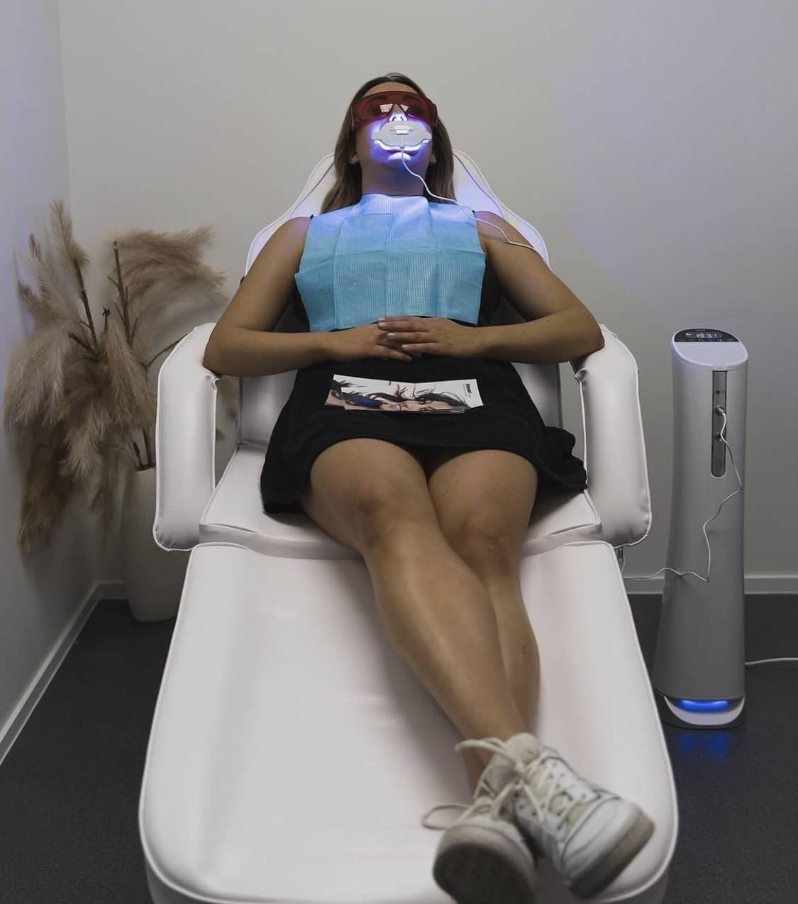 Woman sitting in chair getting professional teeth whitening