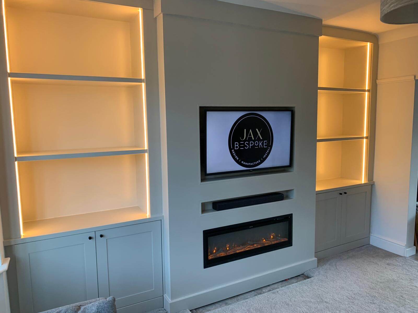 Bespoke Media wall with fireplace, cupboard, shelves and lighting Bespoke Media wall with fireplace, cupboard, shelves and lighting