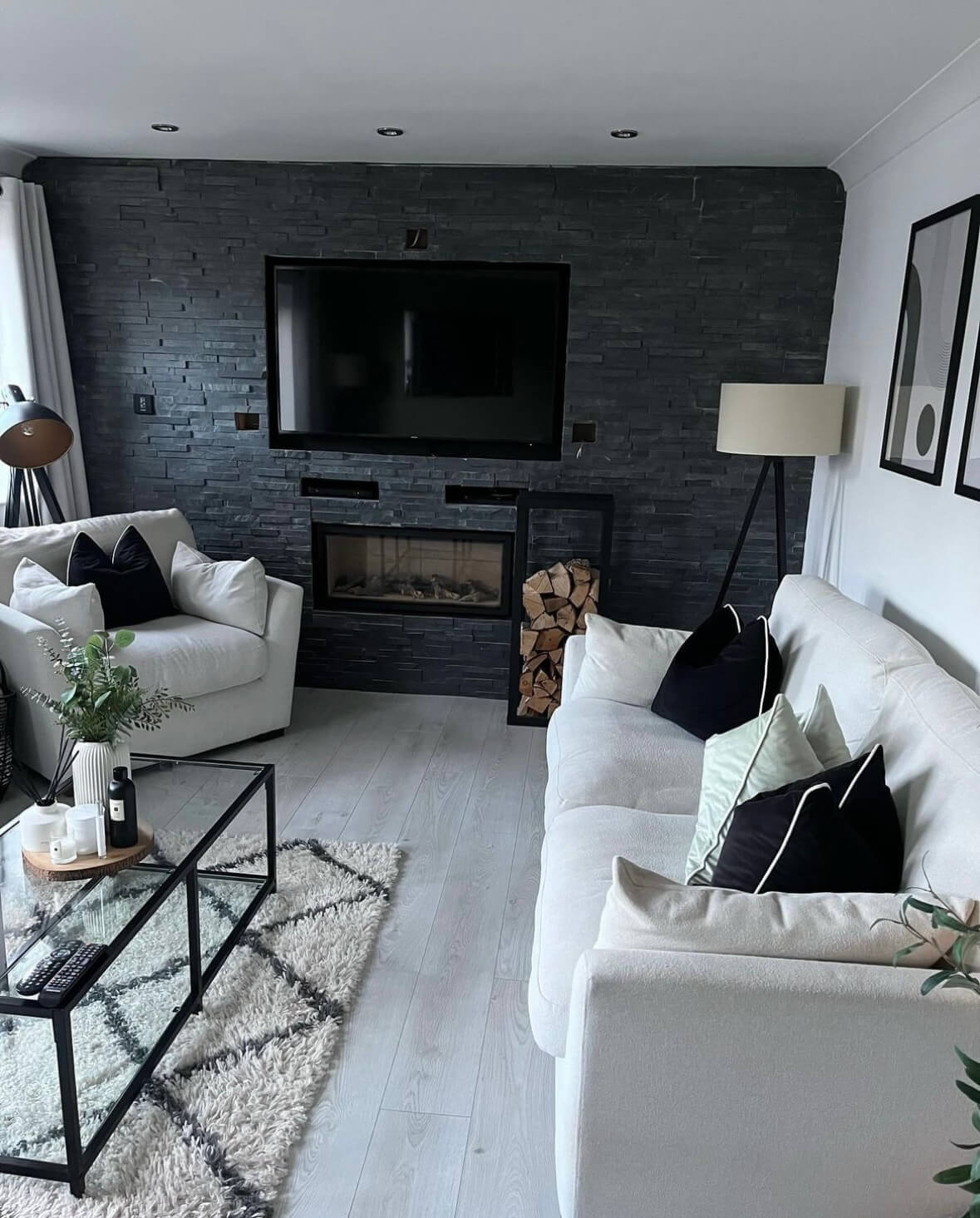 Before photo of a living room featuring an outdated grey tiled media wall and fireplace, showcasing the previous design elements prior to the renovation by JAX Bespoke Before photo of a living room featuring an outdated grey tiled media wall and fireplace, showcasing the previous design elements prior to the renovation by JAX Bespoke
