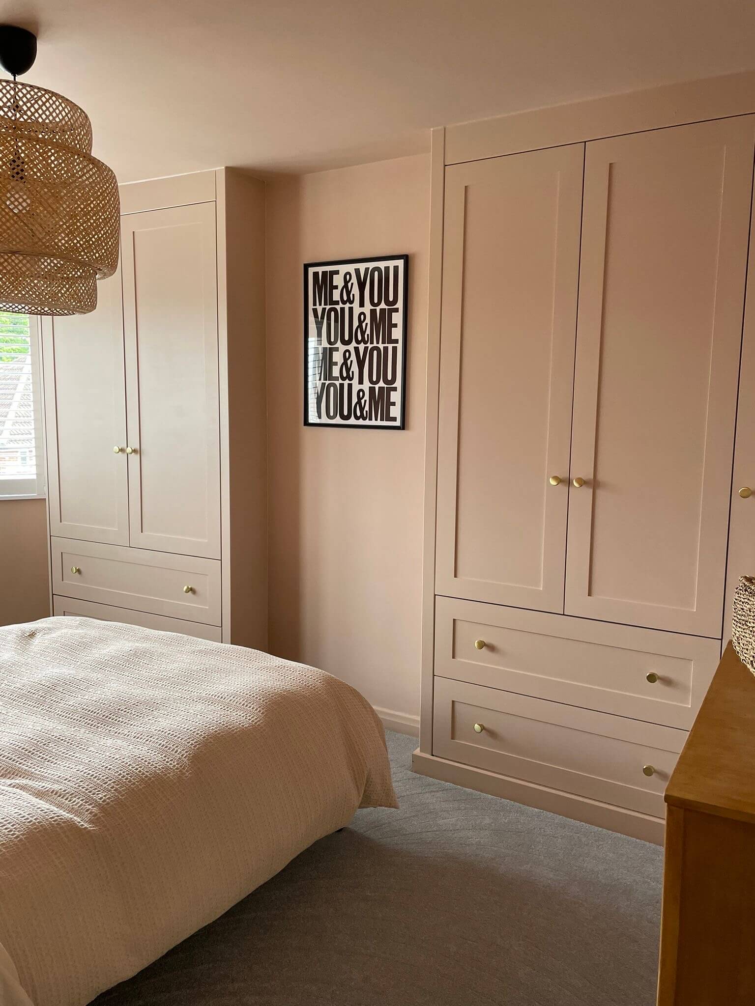 Elegant bespoke fitted wardrobes in a warm blush pink with shaker-style doors and brass knobs, designed around a chimney breast in a Yorkshire bedroom. Created by JAX Bespoke with 0% finance options available. Elegant bespoke fitted wardrobes in a warm blush pink with shaker-style doors and brass knobs, designed around a chimney breast in a Yorkshire bedroom. Created by JAX Bespoke with 0% finance options available.