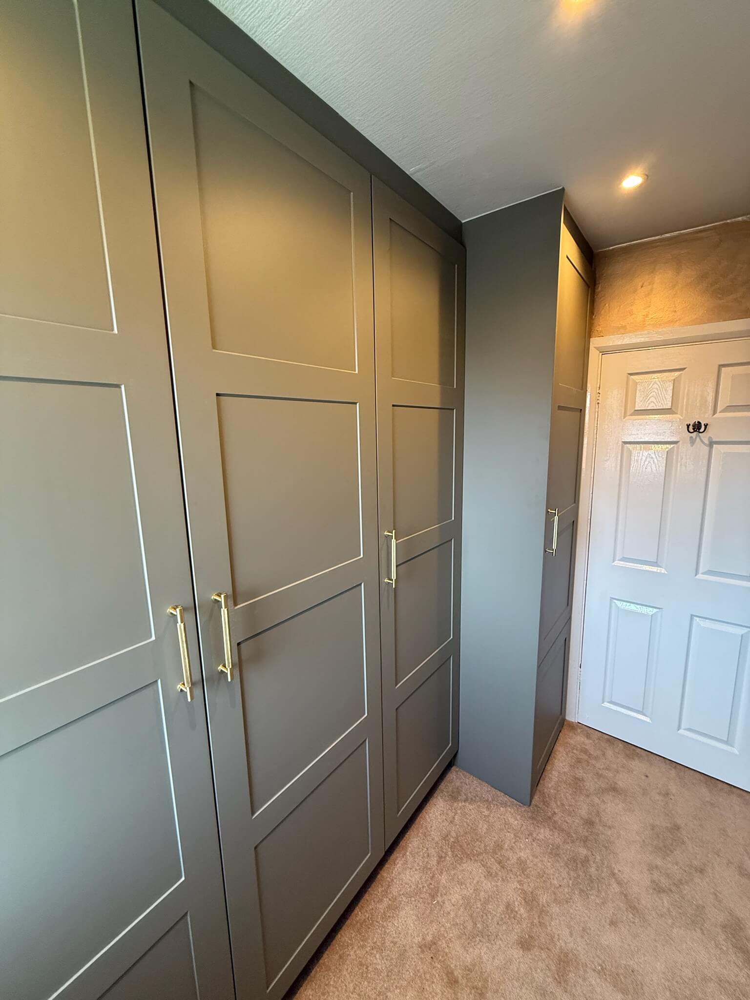 Leeds, Yorkshire Made to measure bespoke walk in wardrobe with sage green shaker style doors in Wakefield home by JAX Bespoke Leeds, Yorkshire Made to measure bespoke walk in wardrobe with sage green shaker style doors in Wakefield home by JAX Bespoke