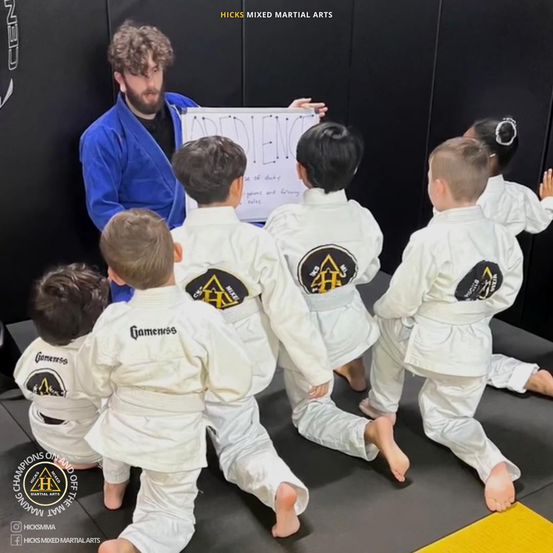 Kids BJJ class at the end of class learning the word of the week. Kids BJJ class at the end of class learning the word of the week.