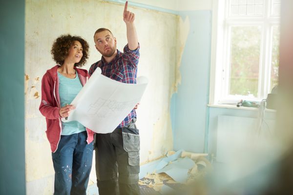 couple planning and holding blue print couple planning and holding blue print