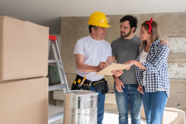 couple talking with a contractor smiling couple talking with a contractor smiling