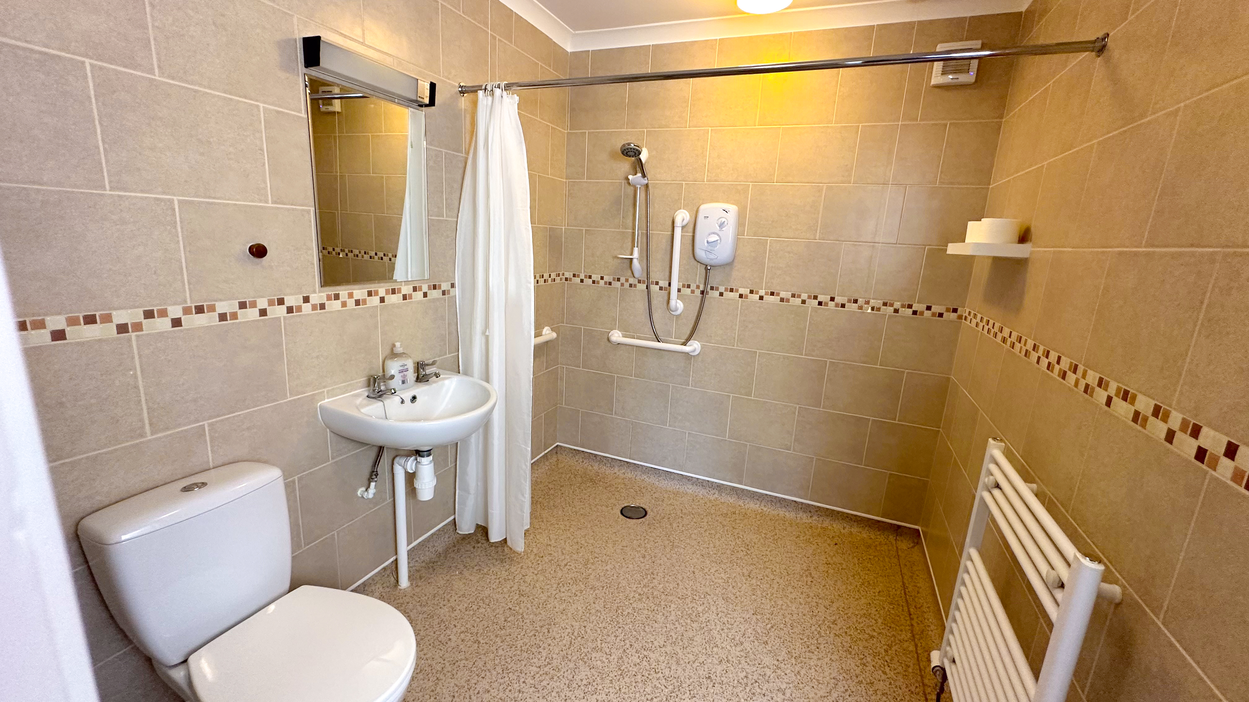 Showing the wet room in a property for people travelling with disability and mobility issues Showing the wet room in a property for people travelling with disability and mobility issues