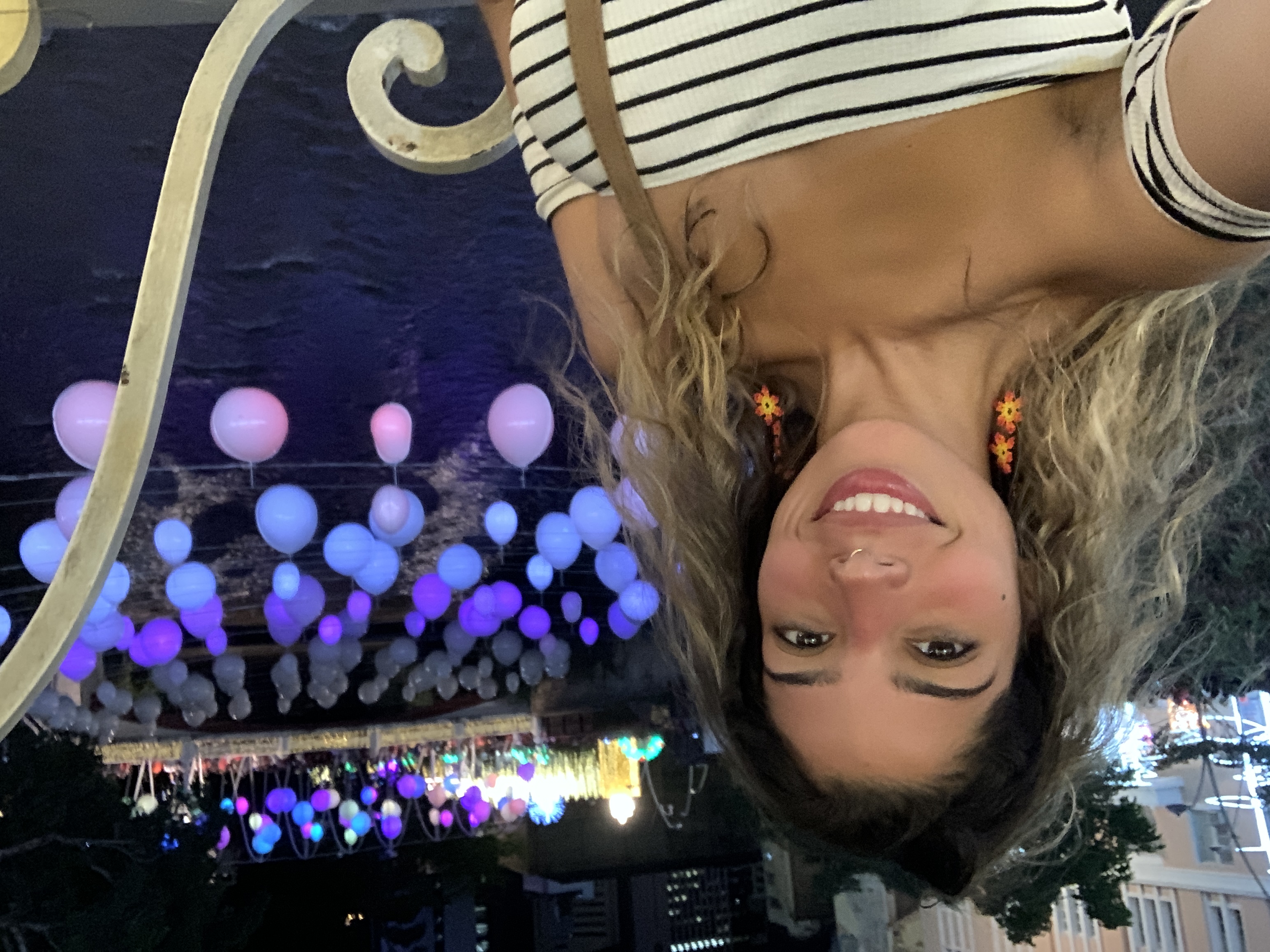 woman picture in front of a river and hanging lights in cali colombia woman picture in front of a river and hanging lights in cali colombia