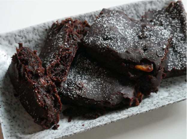 A closeup of baked brownies made from black beans