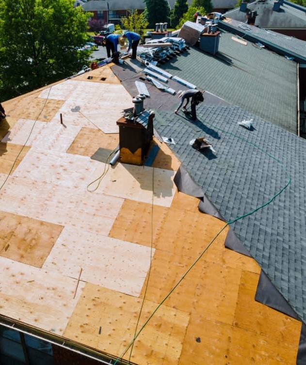 a group of expert roofers fixing a roof