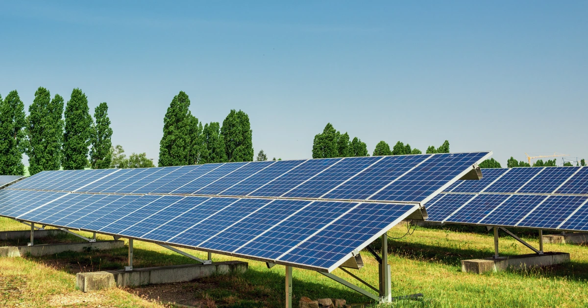 Ground-mounted solar panels installed on a green field. Ground-mounted solar panels installed on a green field.