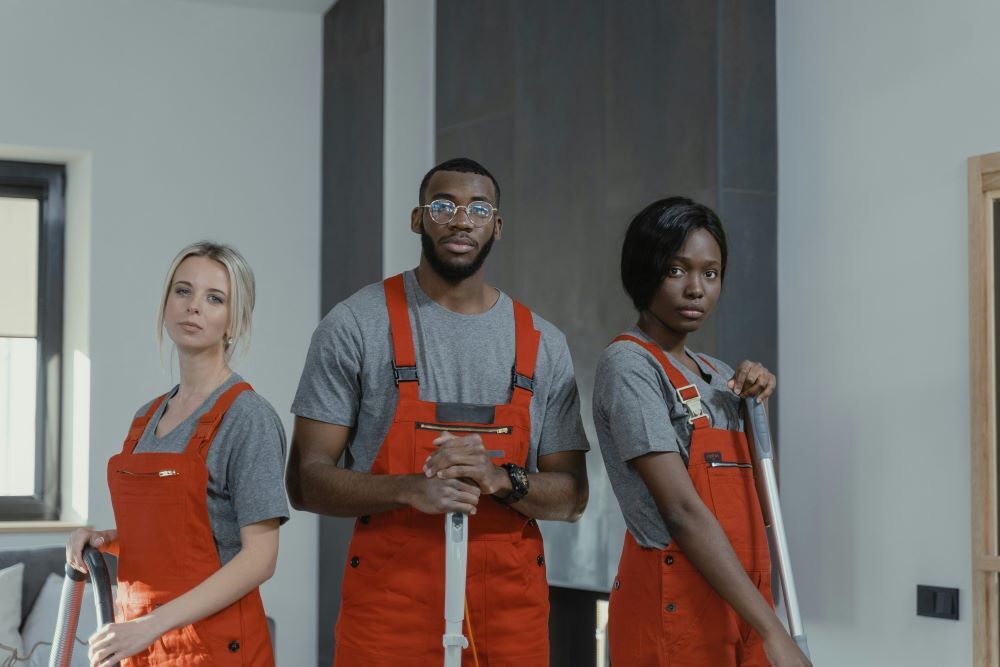 Three people cleaning a home