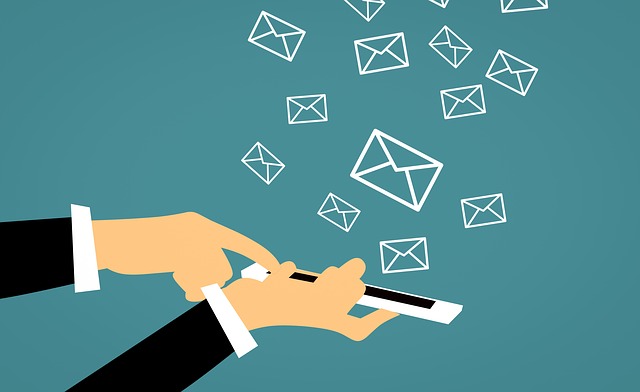 Graphic of a phone in a hand with envelopes popping out of the screen on a blue background.