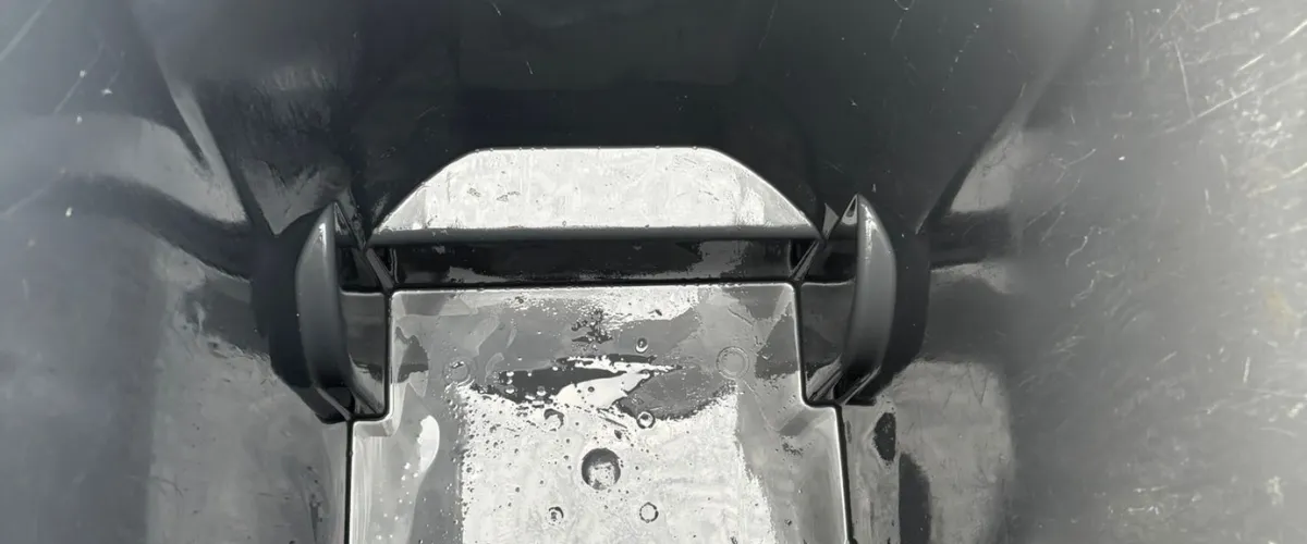 Close-up view of the inside of a clean garbage bin after washing