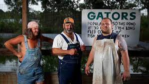 red necks standing next to a truck